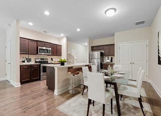 Omnia at Richmond Hill Townhomes in Georgia photo of a kitchen and dining room with a table and chairs