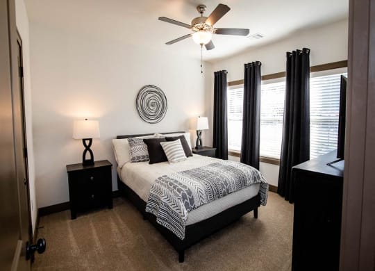 a bedroom with a bed and a ceiling fan