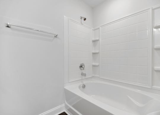 a white bathroom with a white tub and a shower