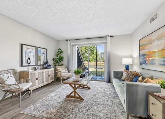 A living room with a sofa, chair, and a table.