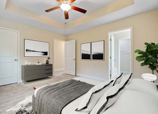 Omnia at Richmond Hill Townhomes in Georgia photo of a bedroom with a bed and a ceiling fan.