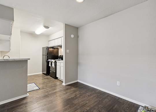 A kitchen area with a refrigerator, microwave, and oven.