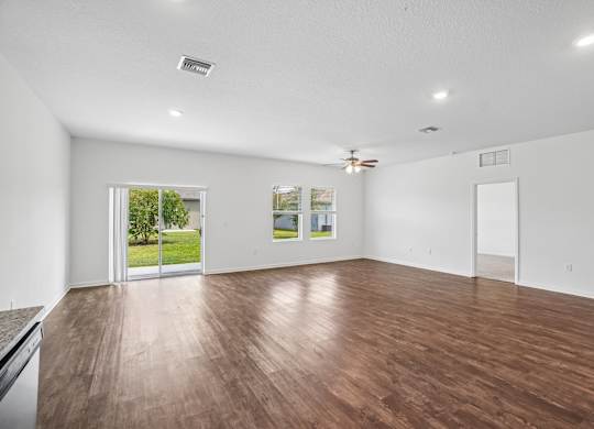 A room with wooden floors and white walls.