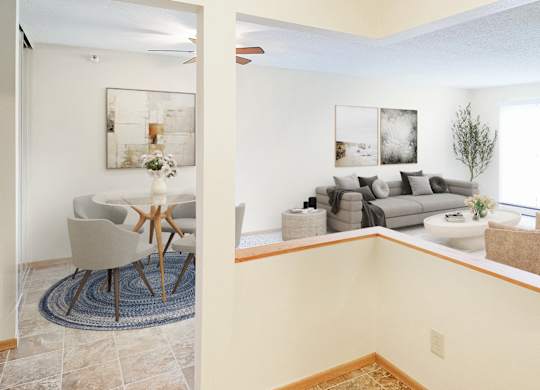 A living room with a couch, chair, and a painting on the wall.
