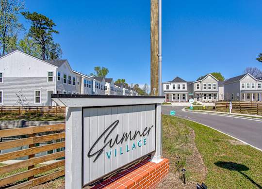 Townhomes North Charleston, SC - Sumner Village - Property Sign at the Entrance to the Driveway Leading to Rows of Homes.