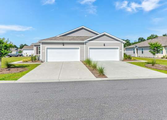 a house with a white garage door in front of a driveway