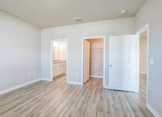 a renovated living room with wood flooring and white walls