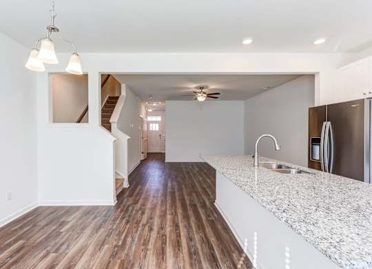 an empty kitchen with a counter top and a sink