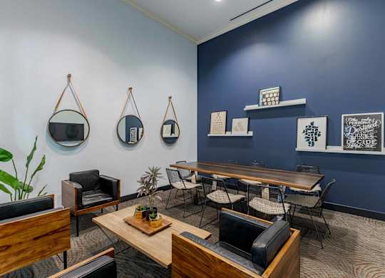 A room with a blue wall and a wooden table with chairs.