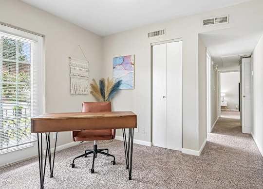 A room with a brown table and a chair.