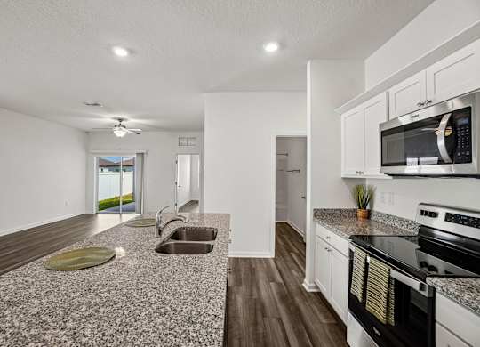 A kitchen with a microwave on the counter.