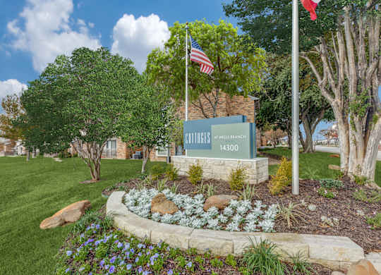 A sign for Bullfrog Creek Estates is in front of a green lawn.