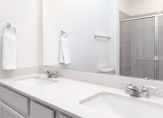 a bathroom with two sinks and a mirror