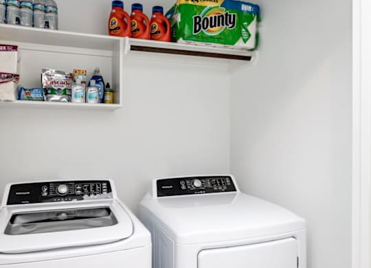 a white washer and dryer sit next to each other in a laundry room