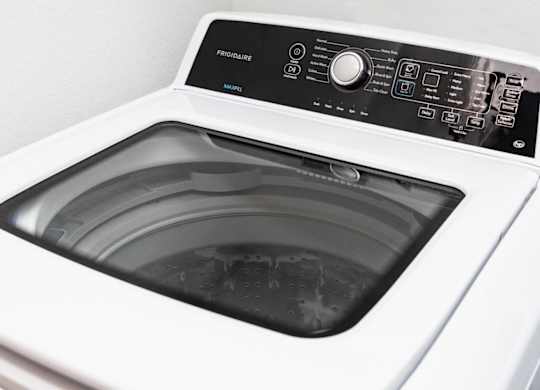 a white washing machine with the door open