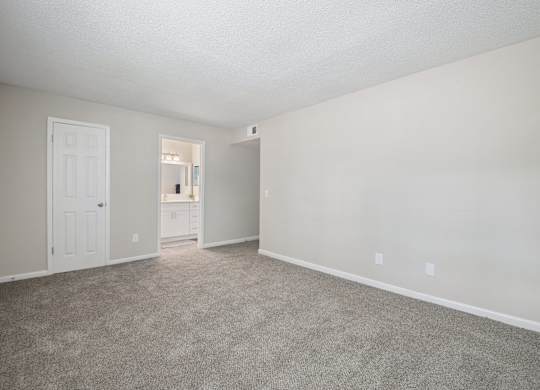 A room with a carpeted floor and white walls.