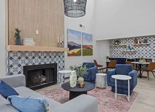 A living room with a fireplace and a painting on the wall.