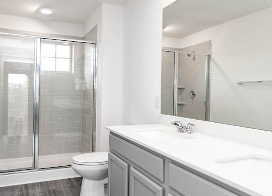 a bathroom with a toilet sink and shower