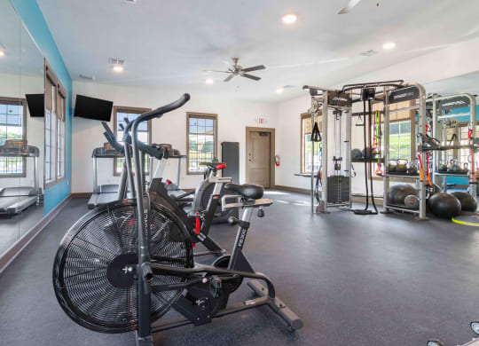 a home gym with exercise equipment and a bike in it
