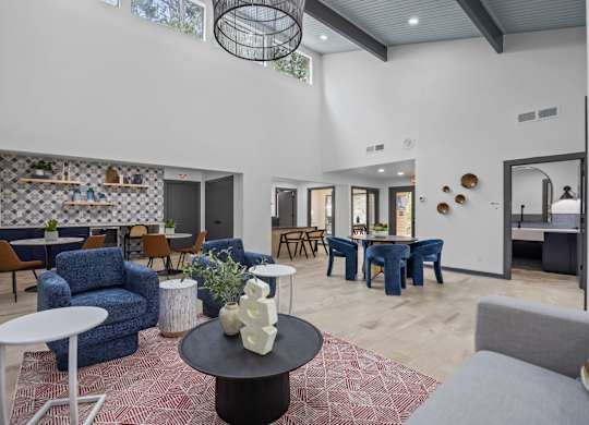 A modern living room with a variety of furniture and decorative items.
