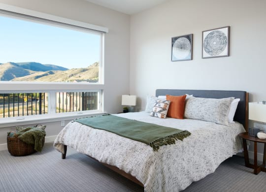 a bedroom with a large bed and a large window