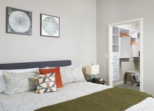 a bedroom with a bed and two pictures on the wall