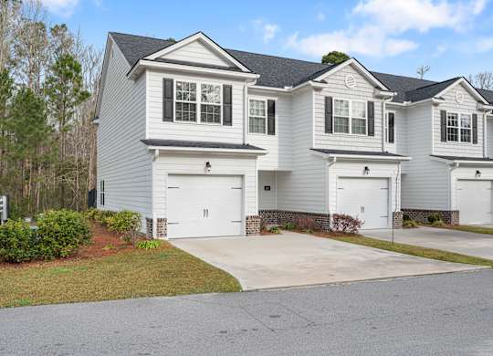 Harris Trail Luxury Townhomes for rent Richmond Hill, GA photo of white townhome with garage