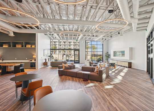 A modern living room with a large window and a wooden floor.