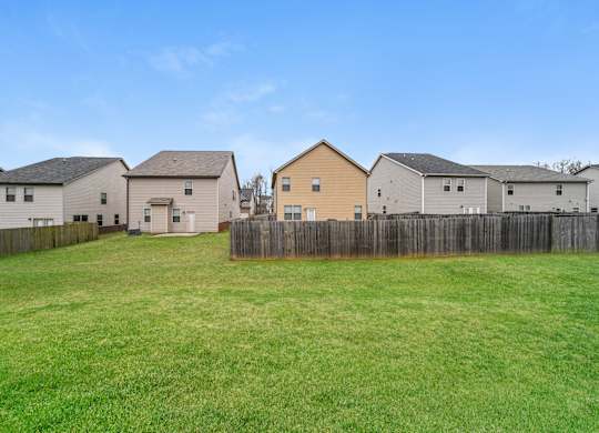 A row of houses with a wooden fence in front of them.