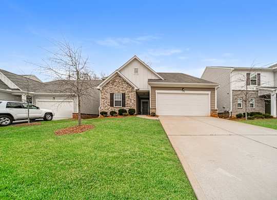 A house with a white garage door and a driveway.