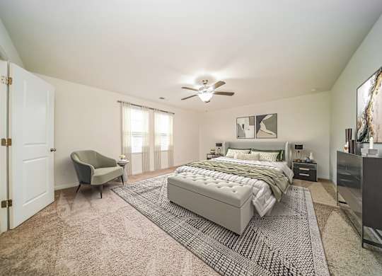 A bedroom with a large bed and a chair.