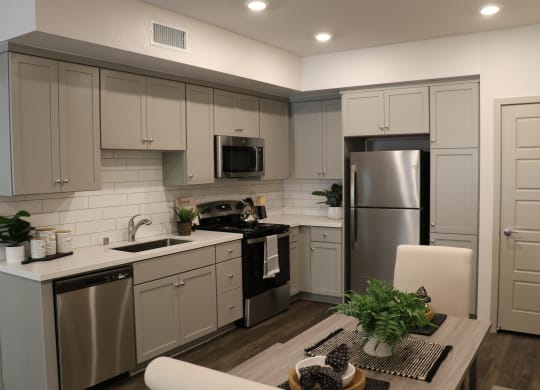 Luxury Apartments in Camarillo, CA- Amelia- Open-Concept Kitchen with Stainless-Steel Appliances and Grey Cabinets