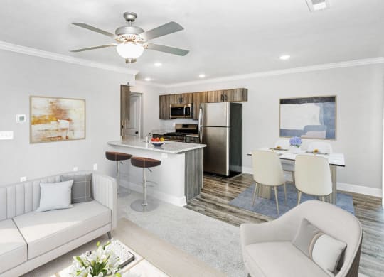 a living room and kitchen with a couch and a table