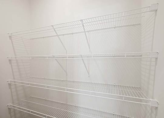 Empty wire shelving unit in a room.