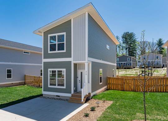 Pet-friendly home for rent in Asheville with fenced backyard, driveway, and modern exterior design.