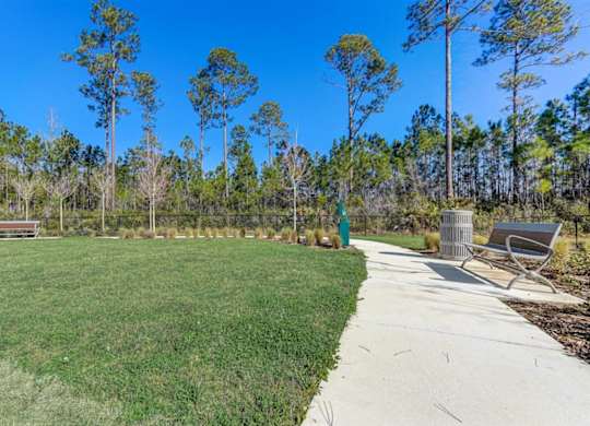 Community park with benches, walking path, and green space.