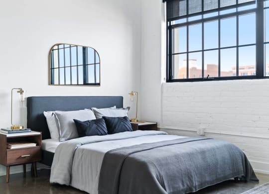 a bedroom with a bed and a window