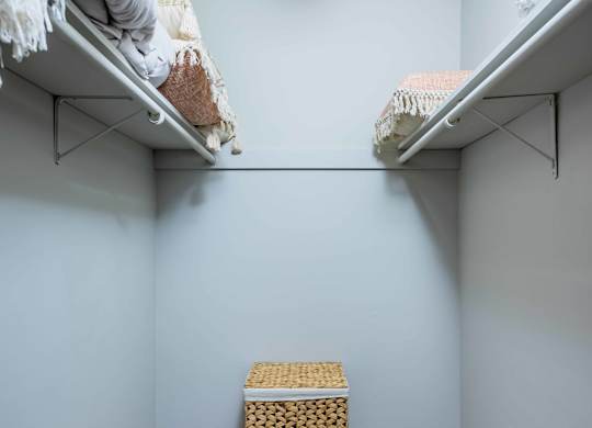 Walk-in closet in spacious apartment at Grand Arbor Reserve Apartments in Raleigh, NC 27607, near Central Raleigh.