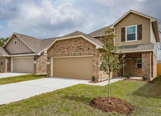 Homes for Rent in Humble TX - Edgewater at the Lagoon - Large House with a Brick Facade, Attatched Garage, and Driveway