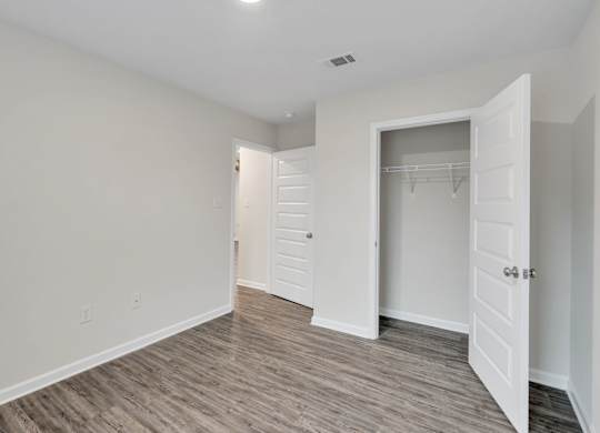 A room with a white door and a white closet.