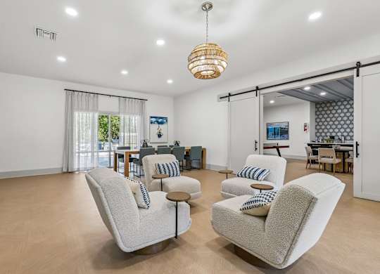 A living room with a white sofa and a wooden table.