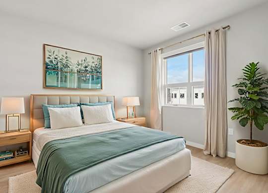 A bedroom with a large bed and a painting above it.