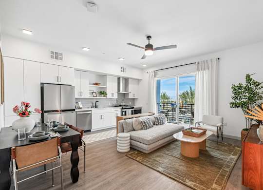 A modern kitchen with a dining table and chairs.