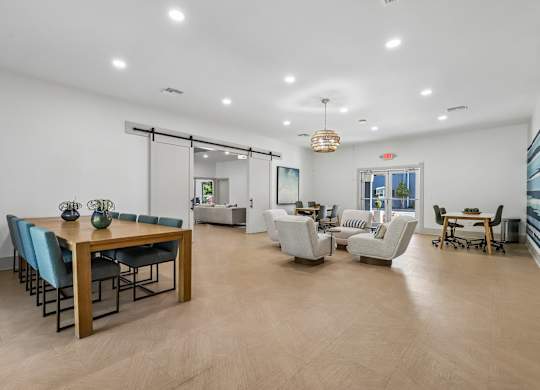 A spacious living room with a dining table and chairs.