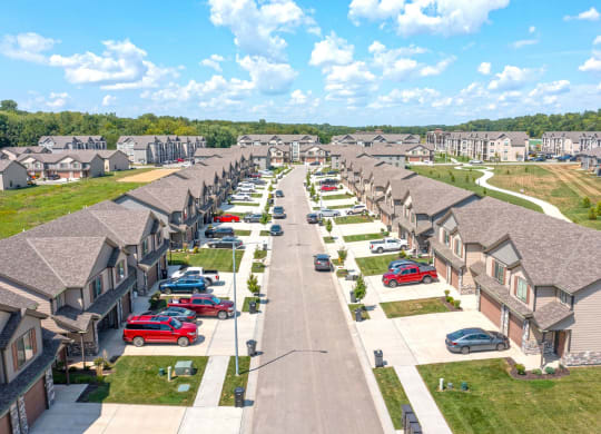 an aerial view of a neighborhood of houses with cars parked