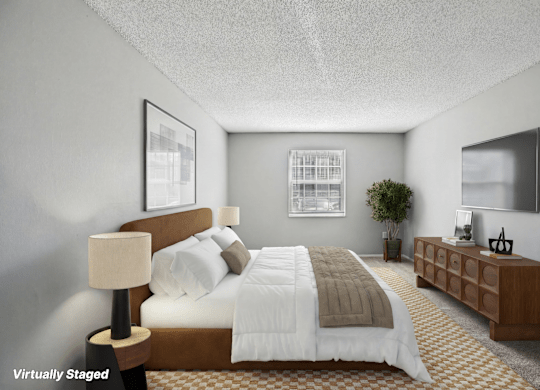 A bedroom with a bed, nightstand, and lamp.