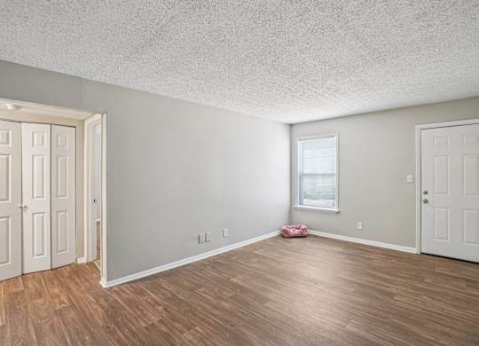 A room with wooden floors and white walls.