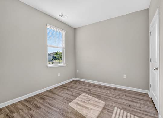 A room with a window and a door.