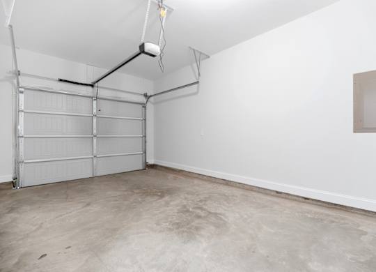 Cottonvale Towns in Savannah, GA photo of the interior of a garage with white walls and a garage door