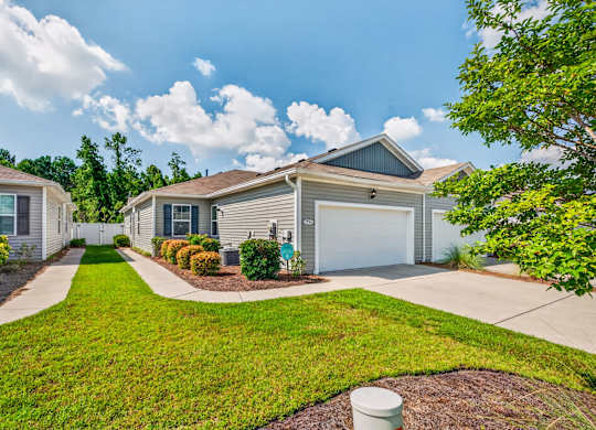 A residential house with a garage and a driveway.